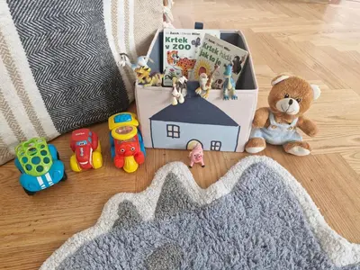 a gift bag with toys and a book on the floor at Prague Green Hideaway near Centre in Prague
