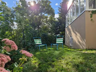 two chairs sitting in the grass in a yard at Prague Green Hideaway near Centre in Prague