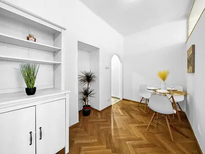 a dining area with a table and chairs in a room at Spacious & Modern Apartment by Wenceslas Square in Prague