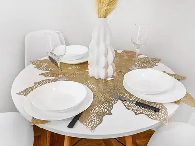 a table with plates and glasses and a vase at Spacious & Modern Apartment by Wenceslas Square in Prague