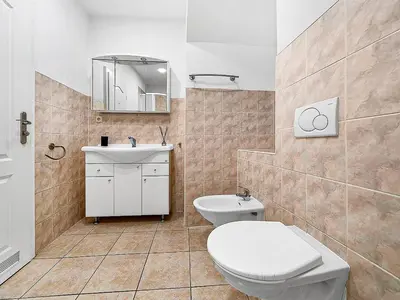 a bathroom with a toilet and a sink at Spacious & Modern Apartment by Wenceslas Square in Prague