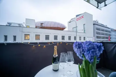 a table with a bottle of wine and two glasses at Světlý byt blízko centra - plně vybavený in Prague