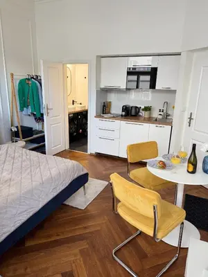 a bedroom with a bed and a table and chairs at Old Town Blue Apartment in Prague