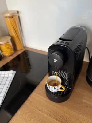 a coffee maker on a desk with a cup of coffee at Old Town Blue Apartment in Prague