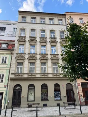 a large building with several windows on a street at Old Town Blue Apartment in Prague