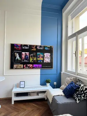 a living room with a couch and a blue wall at Old Town Blue Apartment in Prague