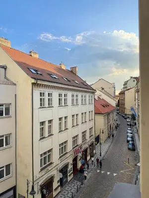 a city street with buildings and people walking on the street at Old Town Blue Apartment in Prague