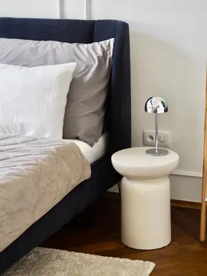 a bed with a white nightstand next to a bed with a white bedskirts at Old Town Blue Apartment in Prague
