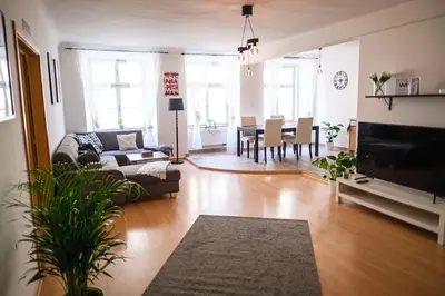 a living room with a couch and a table at Spacious 8-Person Apartment in the Heart of Prague in Prague