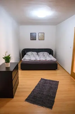 a bedroom with a bed in the corner of a room at Spacious 8-Person Apartment in the Heart of Prague in Prague