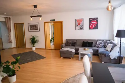 a living room with a couch and a table at Spacious 8-Person Apartment in the Heart of Prague in Prague