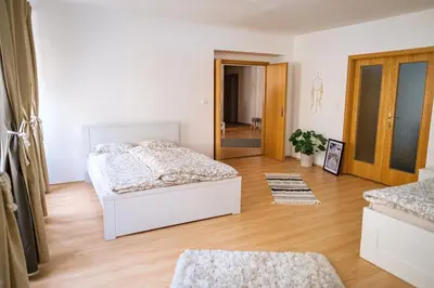 a bedroom with a bed and a wooden floor at Spacious 8-Person Apartment in the Heart of Prague in Prague