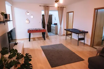 a living room with a table and a desk at Spacious 8-Person Apartment in the Heart of Prague in Prague
