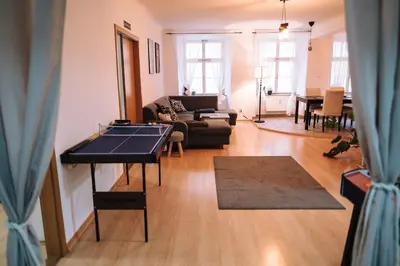 a living room with a ping pong table in it at Spacious 8-Person Apartment in the Heart of Prague in Prague