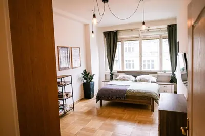 a bedroom with a bed and a window at Bright 120m apartment 2BR Balconies near Castle in Prague