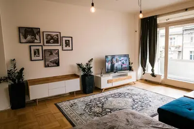 a living room with a flat screen tv on a wall at Bright 120m apartment 2BR Balconies near Castle in Prague