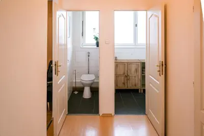 a bathroom with a toilet and a window at Bright 120m apartment 2BR Balconies near Castle in Prague