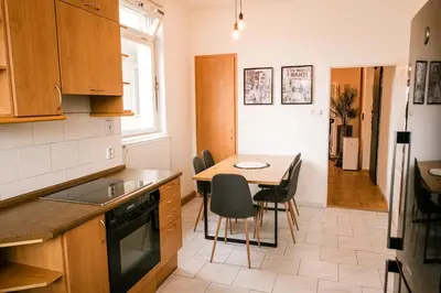 a kitchen with a table and chairs in a room at Bright 120m apartment 2BR Balconies near Castle in Prague