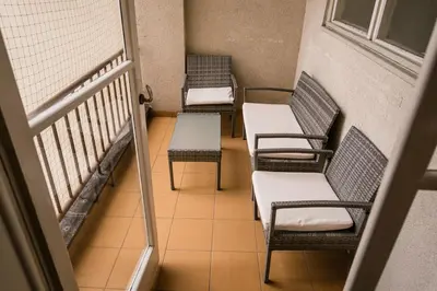 three chairs and a table on a balcony at Bright 120m apartment 2BR Balconies near Castle in Prague