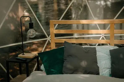 a bedroom with a bed and a lamp on a table at Forest Home Okoř in Okoř