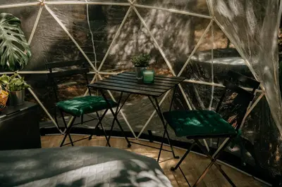 a room with a table and two chairs and a bed at Forest Home Okoř in Okoř