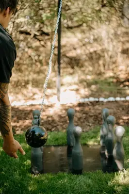 a man is playing with a ball in a pond at Forest Home Okoř in Okoř