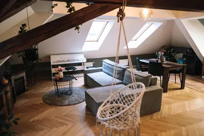 a living room with a hammock in a loft at Charming Attic Apartment in the Heart of Prague in Prague