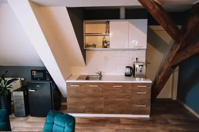 a kitchen with a sink and a refrigerator at Charming Attic Apartment in the Heart of Prague in Prague
