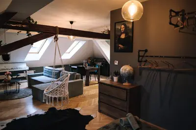 a living room with a couch and a table at Charming Attic Apartment in the Heart of Prague in Prague