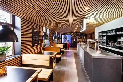 a restaurant with a row of tables and benches at Penzion U Čejpu in Prague