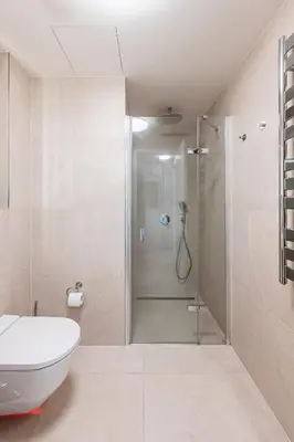 a bathroom with a shower with a toilet and a sink at Prague Days - Bright Studio with Balcony, Netflix and 70Mbs WiFi in Smíchov in Prague