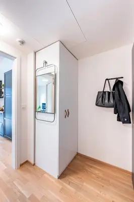 a hallway with a white door and a mirror at Prague Days - Bright Studio with Balcony, Netflix and 70Mbs WiFi in Smíchov in Prague