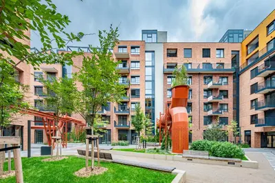 an apartment building with a playground in front of it at Prague Days - Bright Studio with Balcony, Netflix and 70Mbs WiFi in Smíchov in Prague