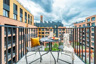 a balcony with a table and two chairs at Prague Days - Bright Studio with Balcony, Netflix and 70Mbs WiFi in Smíchov in Prague