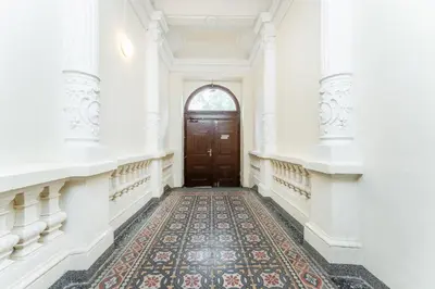 an empty hallway with a door and a rug at Rentero Lublanska Residence - Stylish Lofts in Prague