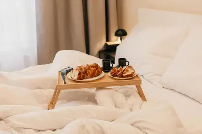 two plates of pastries on a tray on a bed at Maisonette with terrace and view of Prague Castle in Prague