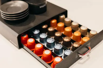 a drawer full of different colored bottles and plates at Maisonette with terrace and view of Prague Castle in Prague