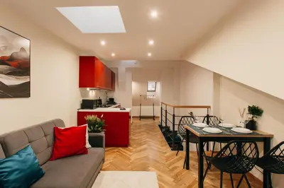 a living room with a couch and a table at Maisonette with terrace and view of Prague Castle in Prague