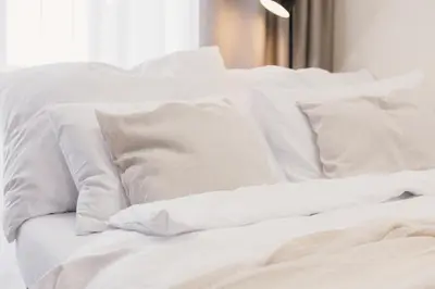 a white bed with white sheets and pillows at Maisonette with terrace and view of Prague Castle in Prague