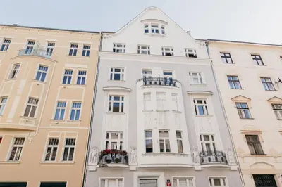a tall white building with windows and balconies at Maisonette with terrace and view of Prague Castle in Prague