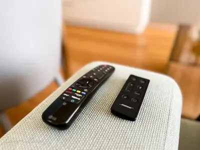 two remote controls sitting on top of a chair at Incredible Luxury Apt with Garage and Tram Station in Prague