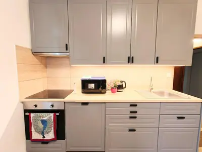 a kitchen with white cabinets and a sink at My sweet place in Prague