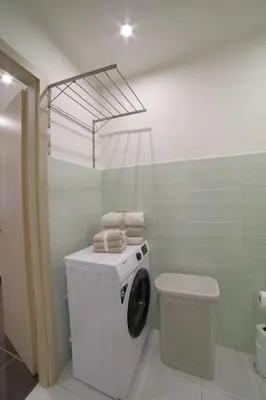 a washing machine in a bathroom with a toilet at Bright & Cozy Apartment with Netflix & Xbox! in Kladno