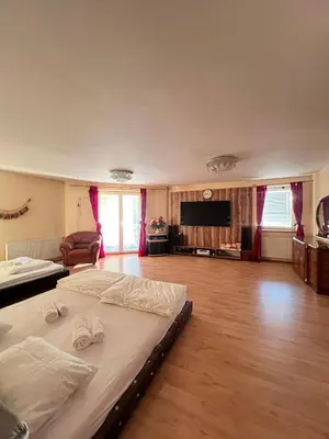 a large bedroom with a bed with two towels on it at Sabina house in Vestec
