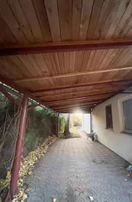 a wooden roof over a walkway under a building at Sabina house in Vestec