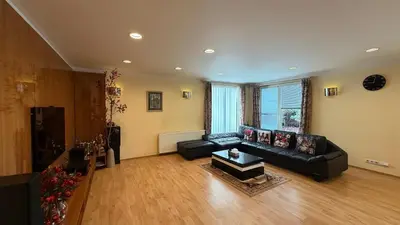 a living room with a black couch and a table at Sabina house in Vestec
