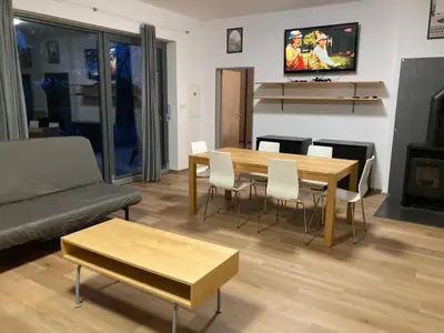 a living room with a table and chairs and a couch at KuK Račice - 3 ložnice in Račice