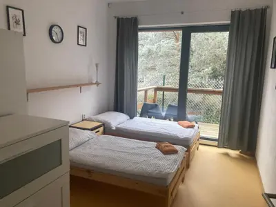 a room with three beds and a window at KuK Račice - 3 ložnice in Račice