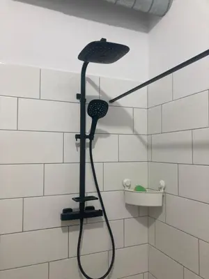 a shower with a black shower head in a bathroom at KuK Račice - 3 ložnice in Račice