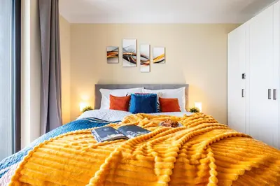 a bedroom with a bed with two books on it at Prague Days - One-Bedroom Apartment with Balcony, Garage & 250 Mbs WiFi in Prague